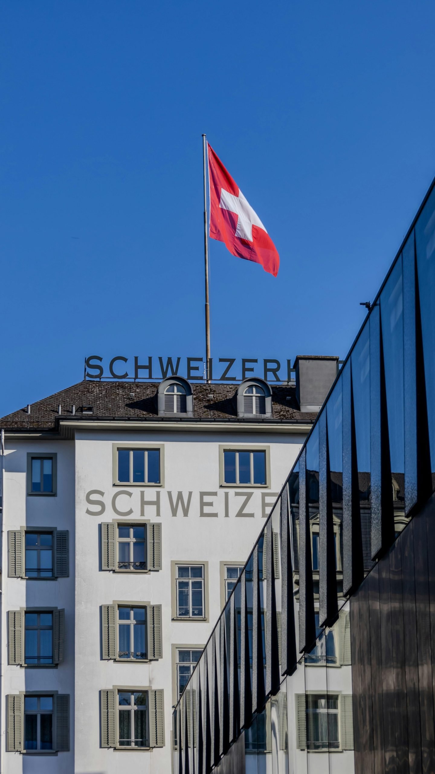 Modern and classic Swiss architecture under a clear sky in Lucerne, Switzerland.